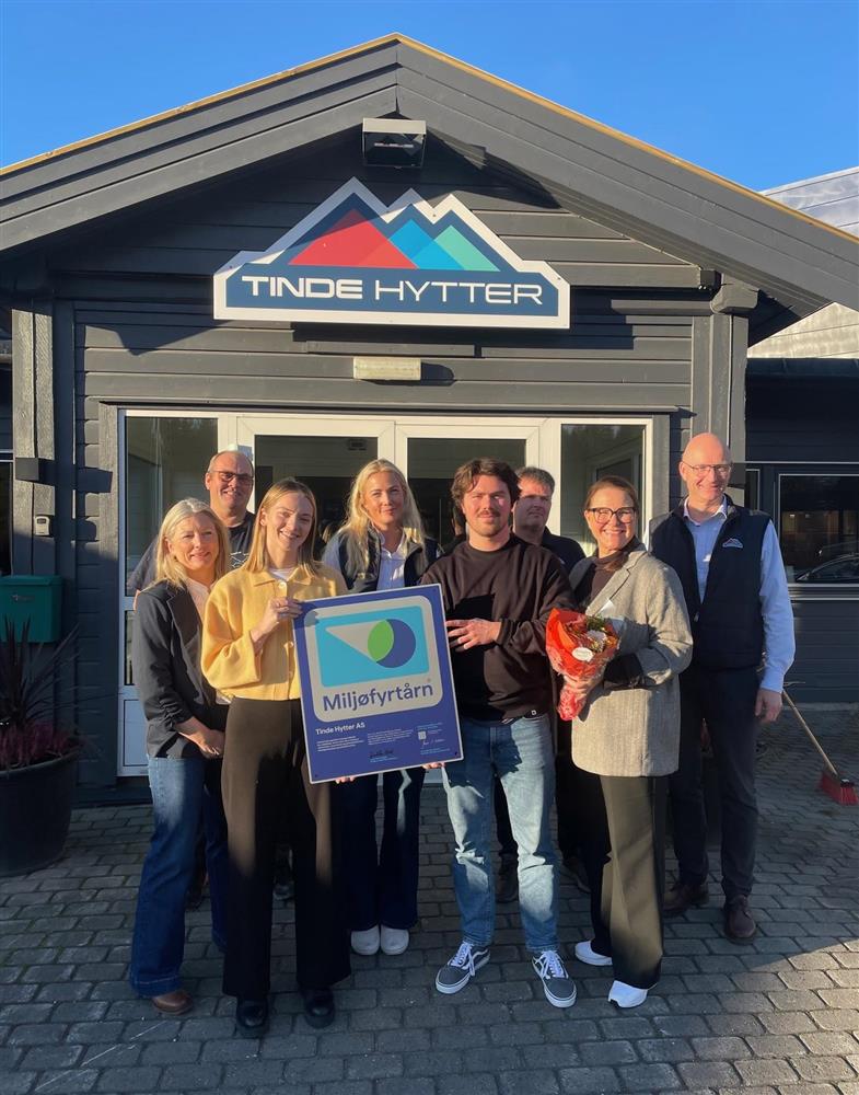 Åtter personer deriblandt ordfører utenfor Tinde Hytter kontor - Klikk for stort bilete